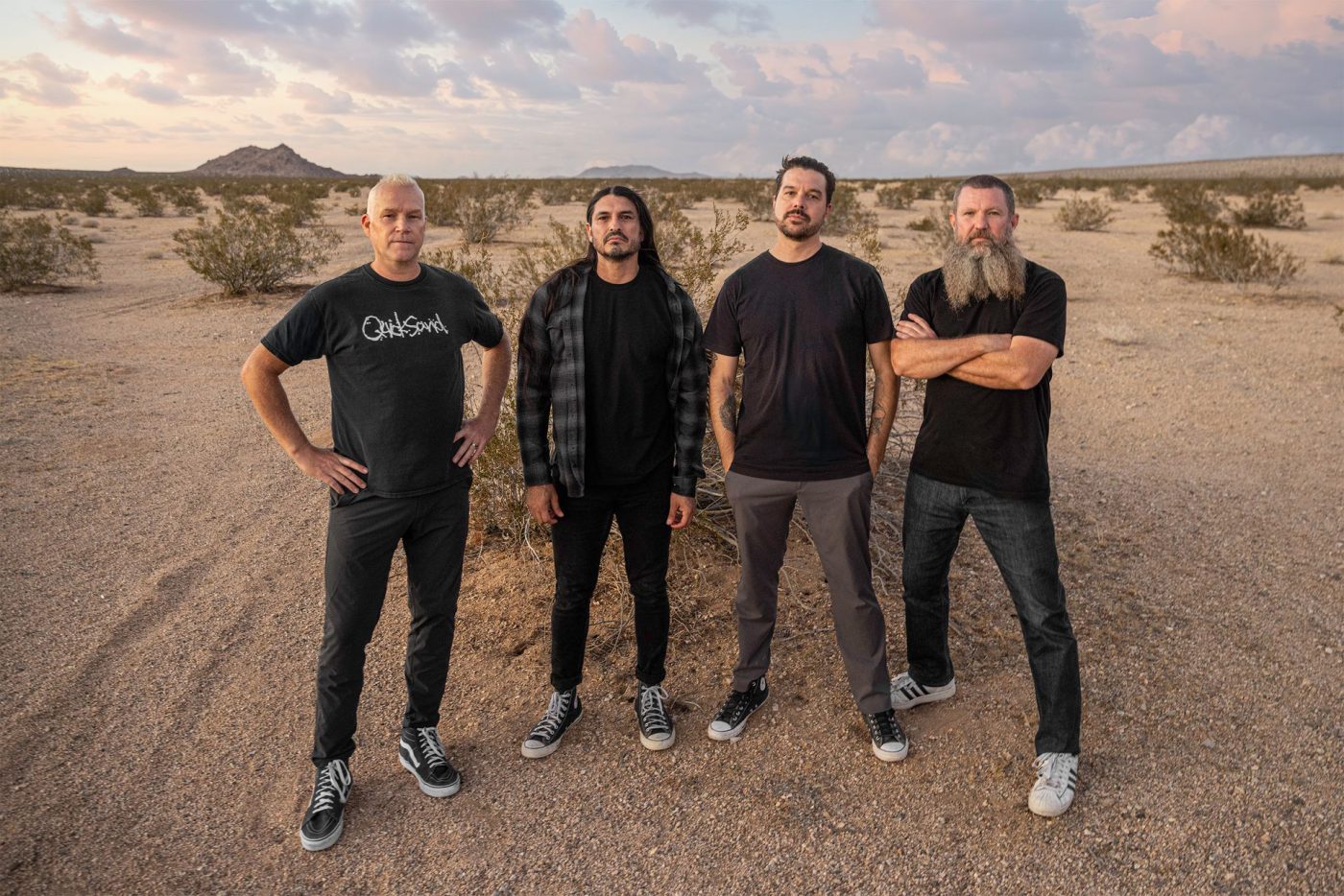 IGNITE band members Eli Santana, Brett Rasmussen, Nik Hill and Craig Anderson standing in the desert