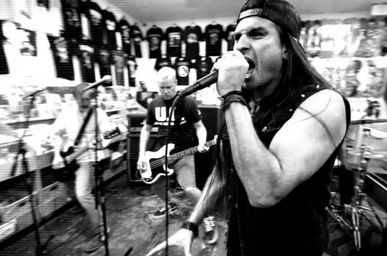 IGNITE playing in a record store in black and white in the music video for This Day
